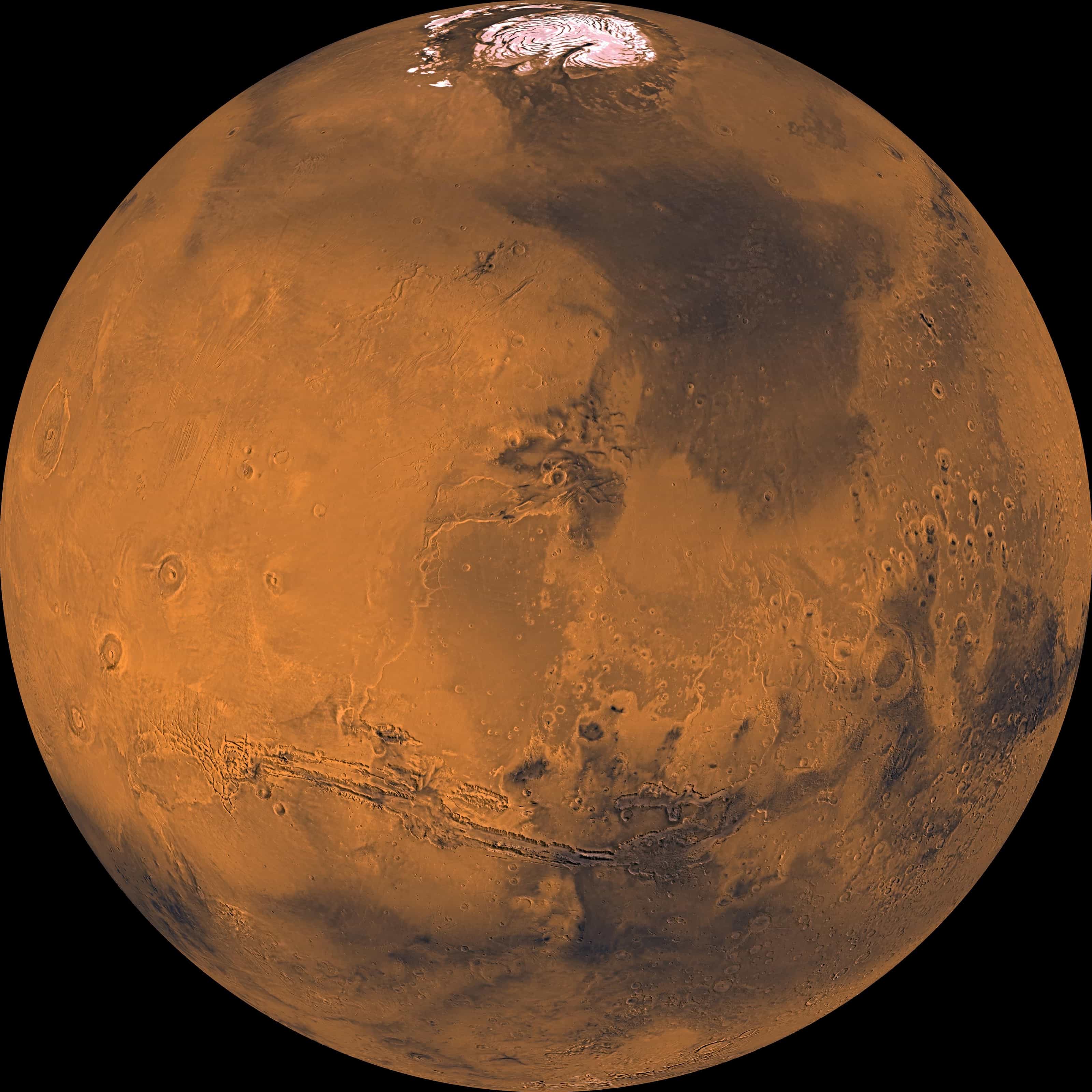 Mars as a full globe in orange-brown, assembled from Viking Orbiter images: the north polar cap at top and the long Valles Marineris canyon system across the lower half.